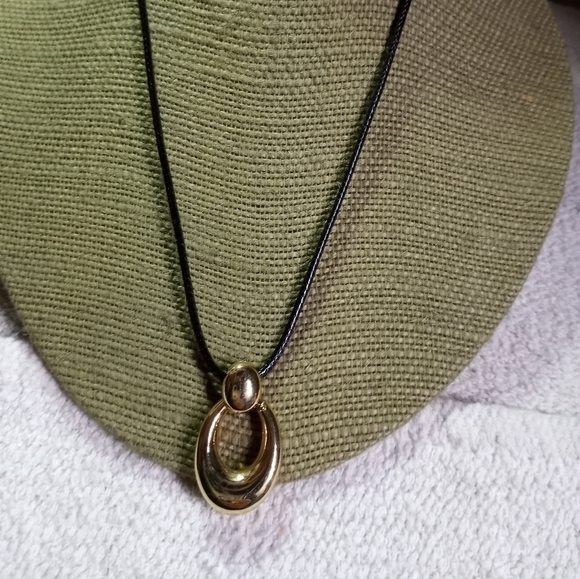 Vintage Jewelry - Goldtone shiny pendant on black cord necklace